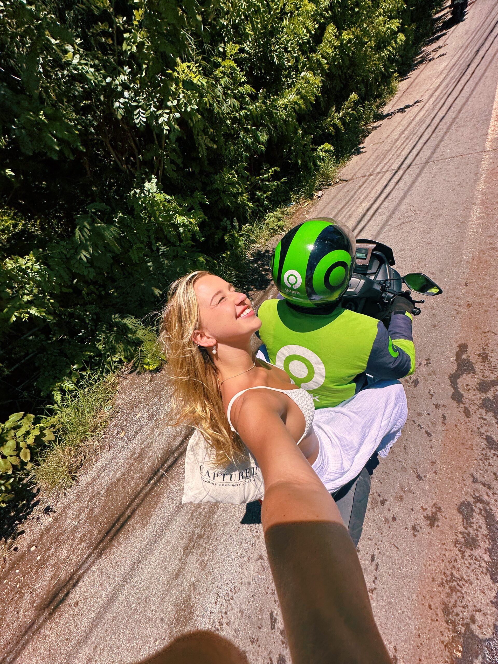 riding on the back of a bike with Gojek